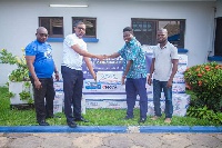 A representative of Ideal Bottling handing over products to the Awareness-General