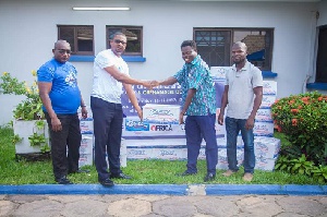 A representative of Ideal Bottling handing over products to the Awareness-General