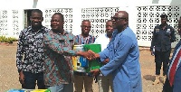 Alhaji Sulemana Alhassan (right) in a handshake with Mr Abudulai Antiku during the presentation