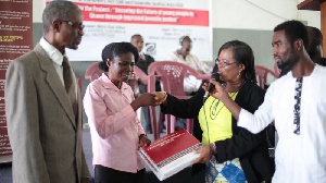 Mrs. Asare , (second from right) presenting copies of the legal documents to Mrs. Narh