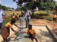 Nana Opoku of Katapei Community pumping water for school children