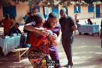 Edem Agbana in a warm embrace with a woman