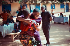 Edem Agbana in a warm embrace with a woman