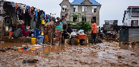 Residents clean up following torrential rains in Kinshasa, DRC, Tuesda, Tuesday, Dec. 13, 2022