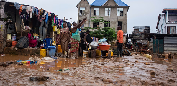 Residents clean up following torrential rains in Kinshasa, DRC, Tuesda, Tuesday, Dec. 13, 2022