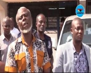 Frederick Yaw Mac-Palm being escorted out of court