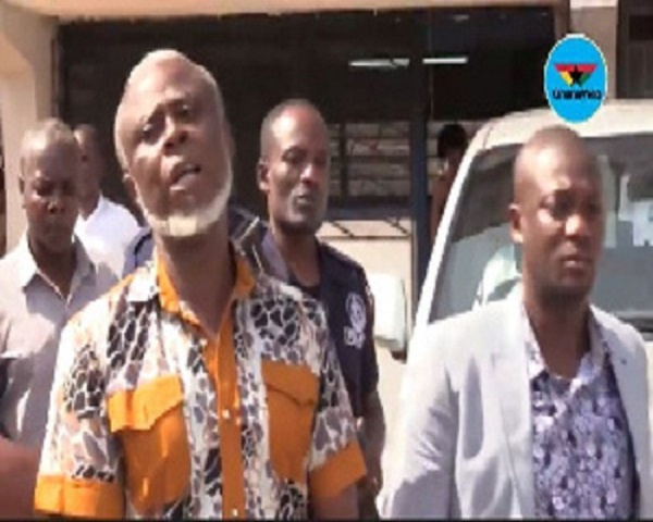 Frederick Yaw Mac-Palm being escorted out of court