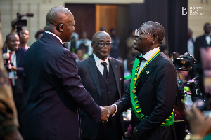 The Asantehene (L) in a handshake with Bright Simons at the ceremony