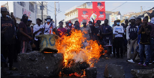 Protesters barricade a road with burning tyres during a nationwide youth-led demonstration