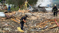 Emergency services clear through the rubble following the Russian missile strike just outside Kyiv
