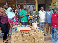 Haruna Abdul Aziz presenting the items to the school authorities