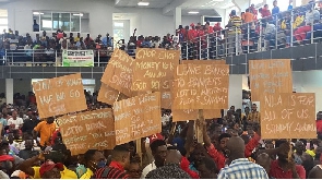 Aggrieved lotto writers holding placards to protest against the reduction of their commission