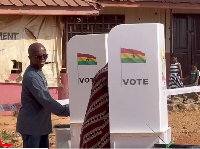 Member of Parliament for Nhyiaeso, Stephen Amoah seemingly stealing glances at a voter's ballot