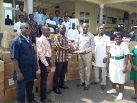 Representatives from the company presenting medications to officials of the Kwahu Gov't Hospital