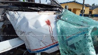 The mangled car with bloodstains