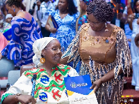 Vice President Opoku-Agyemang presents a citizenship certificate to a new Ghanaian from the diaspora