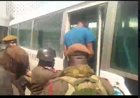 Prison officials escorting the accused person