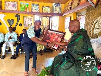 Bernard Okoe Boye receiving a framed photo from Nana Akwasi Bosompra I