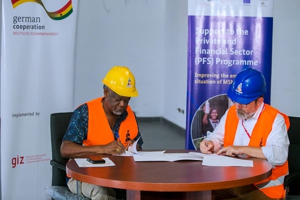 Wilson Tei and Dr. Christian Jahn signing the certificate of donation and exchange