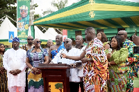 Julius Debrah, Chief of Staff, speaking to the crowd (in white)