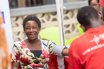 A lady smiling while receiving treatment during Telecel's free health screening execrise