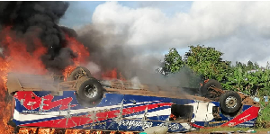 A bus seen in flames after overturning on the Katosi-Nyenga Road in Buikwe District on May 5, 2025