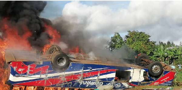 A bus seen in flames after overturning on the Katosi-Nyenga Road in Buikwe District on May 5, 2025