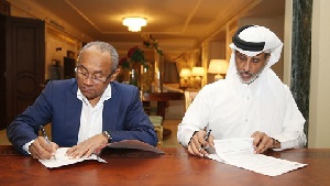 CAF President Ahmad signs the deal with Qatar FA chief Al Thani