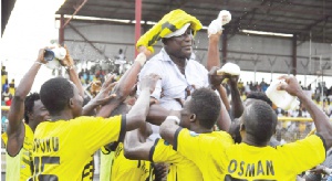 Coach and players of Ashgold jubilating