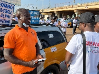 A road safety campaigner speaking with a driver