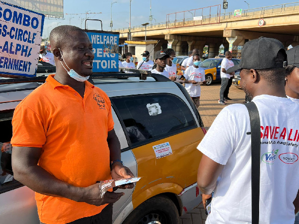 A road safety campaigner speaking with a driver