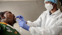 A nurse from Lancet Nectare hospital (R) performs a COVID-19 coronavirus test in Richmond