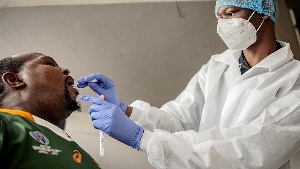 A nurse from Lancet Nectare hospital (R) performs a COVID-19 coronavirus test in Richmond