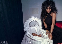 Rihanna poses with her baby in the cradle