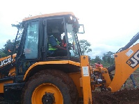 Sports Minister, Isaac Asiamah in an excavator