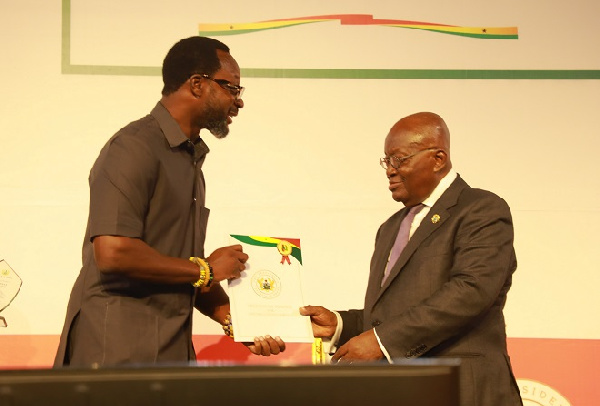 The CEO of MTN Ghana, Selorm Adadevoh receiving the award from President Akufo-Addo