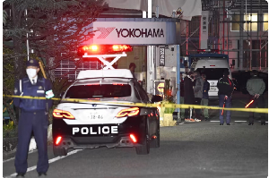 Police officers stand guard at the scene of a stabbing at the Yokohama Rubber Company in Mishima
