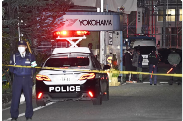 Police officers stand guard at the scene of a stabbing at the Yokohama Rubber Company in Mishima