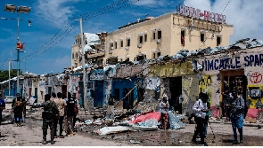 Media report in front of destroyed building after a deadly 30-hour siege by Al Shabaab militias