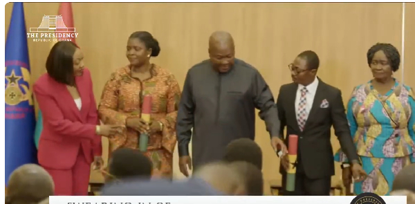 President John Dramani Mahama (M) redirecting Jane Mensah (L)