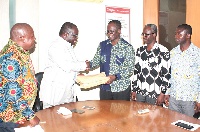 Apostle Samuel Yaw Antwi (3rd right) presenting the signed petitions to Mr Ken Ashigbey (2nd left)