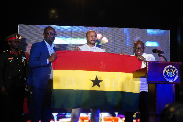Black Stars skipper Dede Ayew and GFA boss receive a flag from president Akufo-Addo
