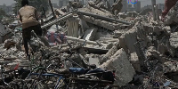 People search through a demolished house in the Gesco neighbourhood of Abidjan