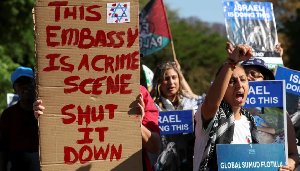Activists hold placards and shout slogans outside Israel's embassy in Pretoria, South Africa Activists hold placards and shout slogans outside Israel's embassy in Pretoria, South Africa