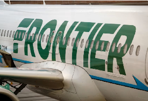 A Frontier Airlines airplane is parked at a gate at San Diego International Airport on May 27