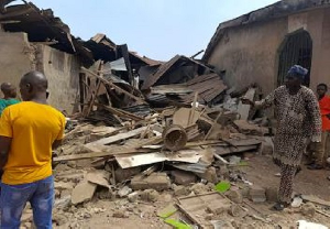 Residents inspect the damage after US forces had launched a strike against Islamic State militants