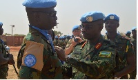 UN Force Commander General, Frank Kamanzi giving medals to officers for their service in South Sudan