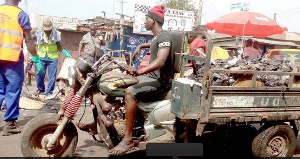 A tricycle carting garbage