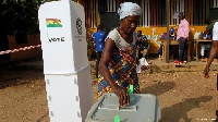 An old woman casting her ballot in a previous election
