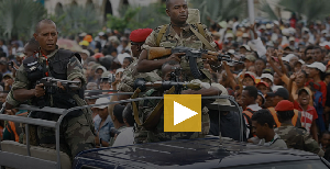 Rebel soldiers lead the convoy bringing opposition leader Andry Rajoelina to a rally in Antananarivo
